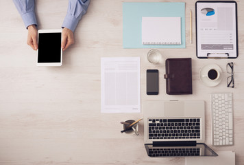 Wall Mural - Businessman working at desk with a digital tablet