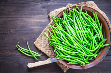 Green beans or fine beans on rustic wood.