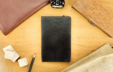 Poster - Wooden Table top with  clock,type box,notebook,leather bag and p