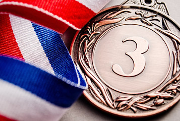 Wall Mural - bronze medal winner at the light background