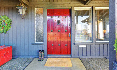 Wall Mural - Beautiful red door and Christmas decor with grey wood house.