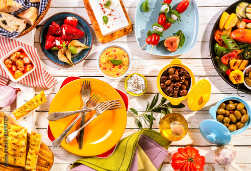 Fotografie, Obraz Colorful Mediterranean Meal on White Picnic Table