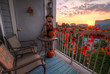 Sunset in autumn as seen from a porch decorated in fall decorations, such as a scarecrow, decorative leaves, and pumpkins. Bethesda, MD.