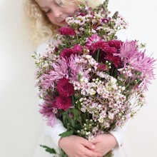 Girl Holding Large Bunch Of Pink Flowers