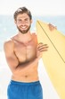 © WavebreakMediaMicro - Handsome man holding surfboard
