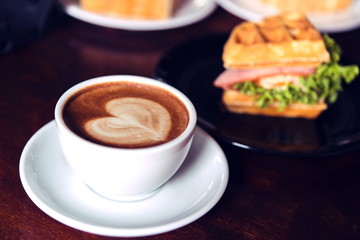 Canvas Print - coffee mocha hot on wooden table on brown background