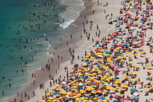 Aerial View At Crowded Beach With Umbrellas In Tropical Climate. Tourists On Ipanema Beach In Rio De Janeiro On A Hot Summer Day