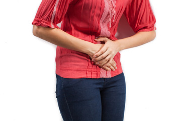 Wall Mural - Young beautiful woman is having stomach ache. Isolated on white.