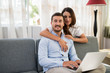 © DragonImages - Loving couple with a laptop