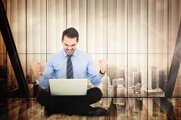 Poster - Composite image of businessman sitting with his laptop cheering