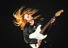 Young Woman With Waving Hair Play Electric Guitar Isolated On Bl