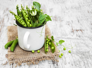 Wall Mural - Metal cup with fresh peas