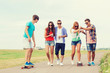 © Syda Productions - group of smiling teenagers with skateboards