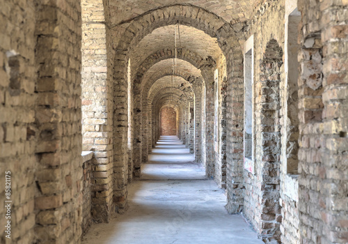 Fototapeta na wymiar Castle tunnel with a series of arches in the ruined Bastion fortress in the Slovak city of Komarno.