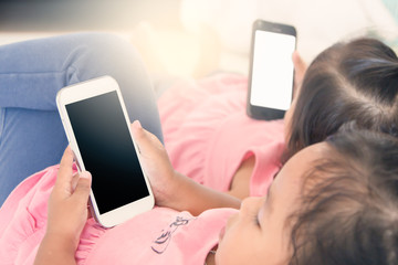 two kids hold smart phone,tablet,cellphone for playing and educa