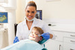 dentist consulting little patient in office