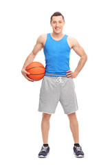 Canvas Print - Young male athlete holding a basketball