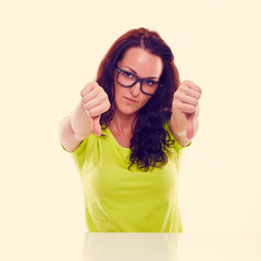 Wall Mural - Sad girl shows gesture with thumbs down. Toned