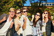 © Syda Productions - group of happy friends showing triumph gesture