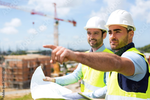 Fotografie, Obraz Worker and architect watching some details on a construction