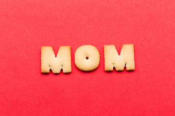 Wall Mural - Word mom cookie over the red background