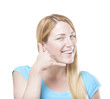 © Denis Rozhnovsky - Blonde gesturing phone sign and smiling. Isolated on white.