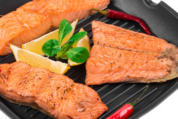 Canvas Print - Fried salmon fillet in pan with lemon.