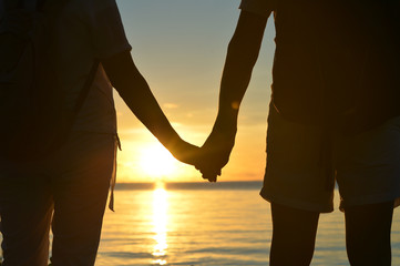 Wall Mural - Senior couple at sea at sunset