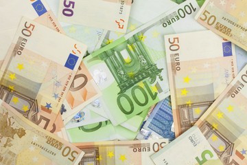 Wall Mural - Euro banknotes scattered on the table. Background made with valid euro banknotes.