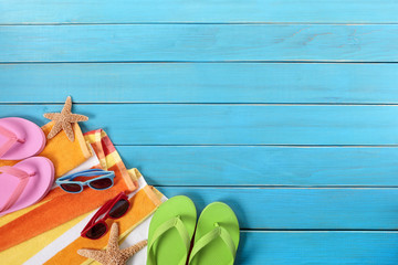 Beach background with old blue wood wooden deck decking boardwalk plank sunglasses and towel couple relaxing sunbathing summer holiday vacation photo