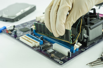hand holding random access memory to install in socket