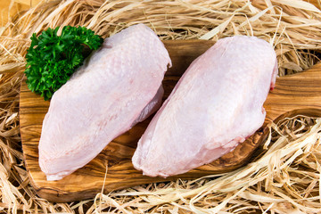 Wall Mural - farm free range chicken breast on cutting board and straw