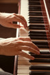 Hands playing the piano