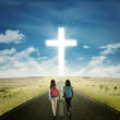 © Creativa Images - Two students walking toward a cross