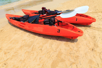 Red kayak on sea beach