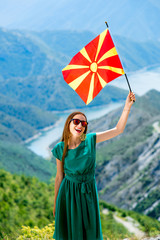 Wall Mural - Woman with macedonian flag on the top of mountain