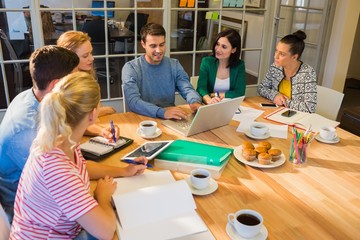 Wall Mural - Colleagues using laptop at office