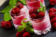 Raspberry granita with berries and mint in glass cups, selective