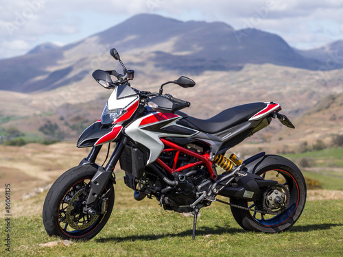 Fotografie, Obraz A supermotard type motorcycle with cloud in its background