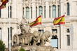 Cibeles Fountain in Madrid and Spanish flags