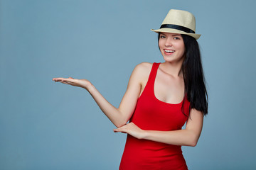 Wall Mural - Young woman showing holding on the palm blank copy space over bl