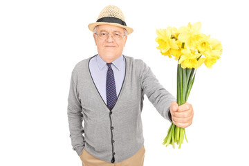 Wall Mural - Senior gentleman handing a bunch of tulips