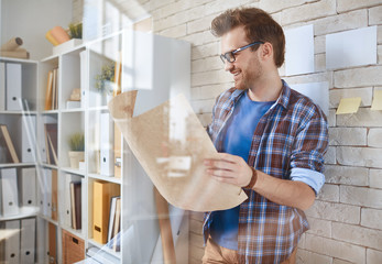 Canvas Print - Young engineer with draft