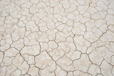 Fototapeta  - Desert textured background of dry cracked earth in in dry lake, Death Valley National Park, California