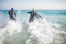 Swimmers Running In The Ocean