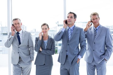 Wall Mural - Employees using their mobile phone