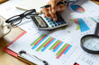 © Kittiphan - Desk office business financial accounting calculate, Graph analy