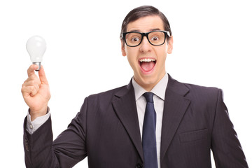 Poster - Excited businessman in a black suit holding a light bulb