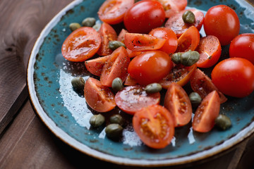 Sticker - Sliced tomatoes with caper berries, salt and pepper, close-up