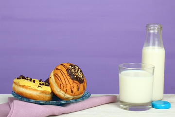 Wall Mural - Donuts and glass of milk on wooden background